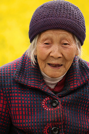 Chinese grandma in canola fields