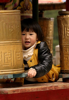 Chinese girl in prayer wheels